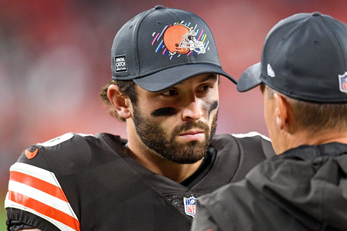 Baker Mayfield talks with a trainer in the fourth quarter against the Arizona Cardinals. The Browns QB has multiple injuries in his non-throwing shoulder.