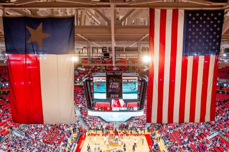 The Texas flag and the American flag hang in the rafters. The NAACP recently called on athletes to avoid Texas in free agency over recent state laws
