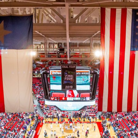 The Texas flag and the American flag hang in the rafters. The NAACP recently called on athletes to avoid Texas in free agency over recent state laws