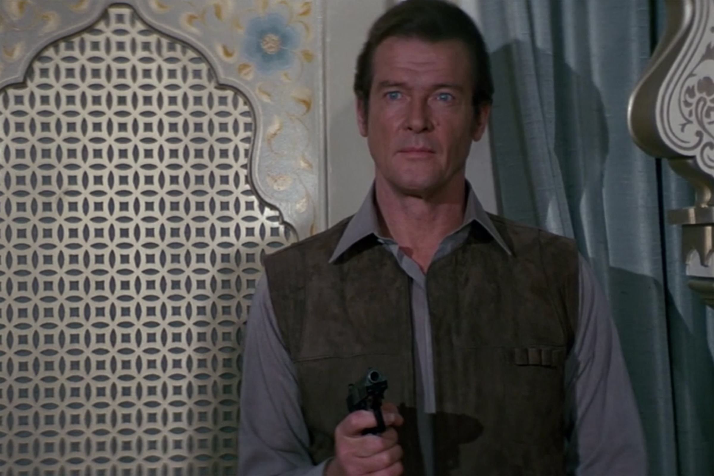 Roger Moore in a simple grey button down in Octopussy.