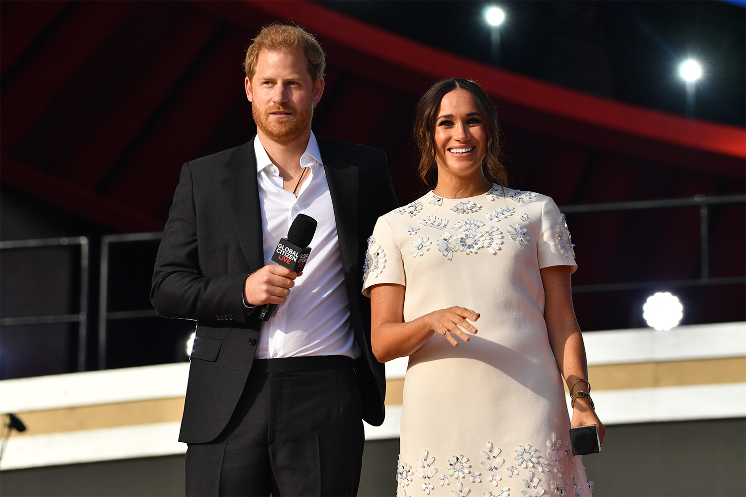 Prince Harry and Meghan Markle, the Duke and Duchess of Sussex, holding microphones onstage at Global Citizen Live on September 25, 2021 in New York City