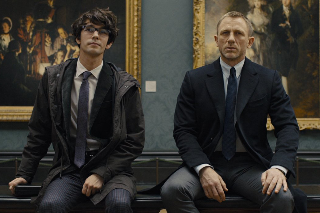 Daniel Craig sports a navy overcoat, a grey trouser and a simple knit tie in Skyfall.