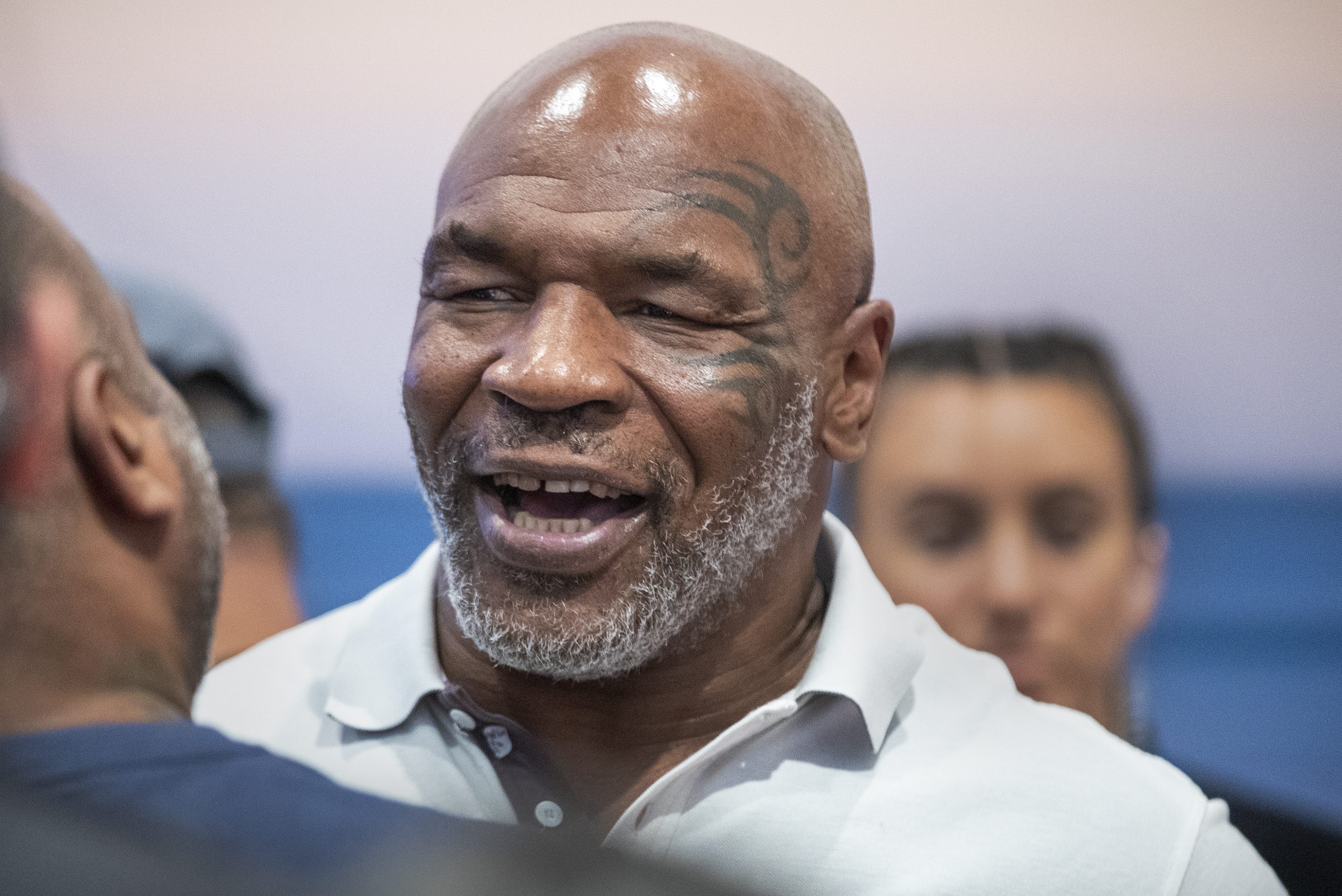 Ex-heavyweight champion Mike Tyson signing autographs in 2021. He recently said he'd be open to fighting Jake Paul or Logan Paul in a boxing match.