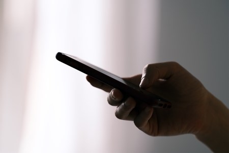 A person holding their phone in one hand. Could they have smartphone pinkie?