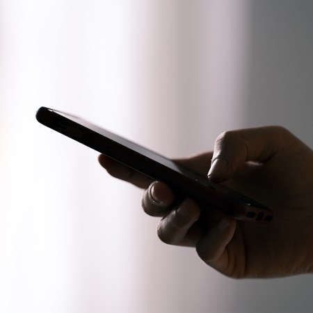 A person holding their phone in one hand. Could they have smartphone pinkie?