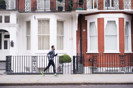 A man jogging down the sidewalk.