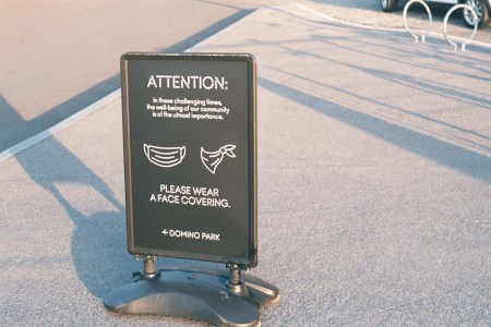 A mask reminding pedestrians to wear face masks. We may have an end in sight for wearing masks.