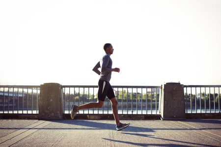 A man running across a bridge