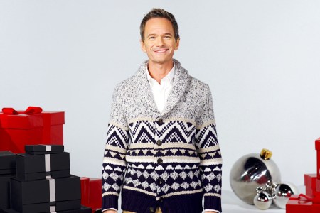 neil patrick harris surrounded by gift boxes wearing a cozy cardigan