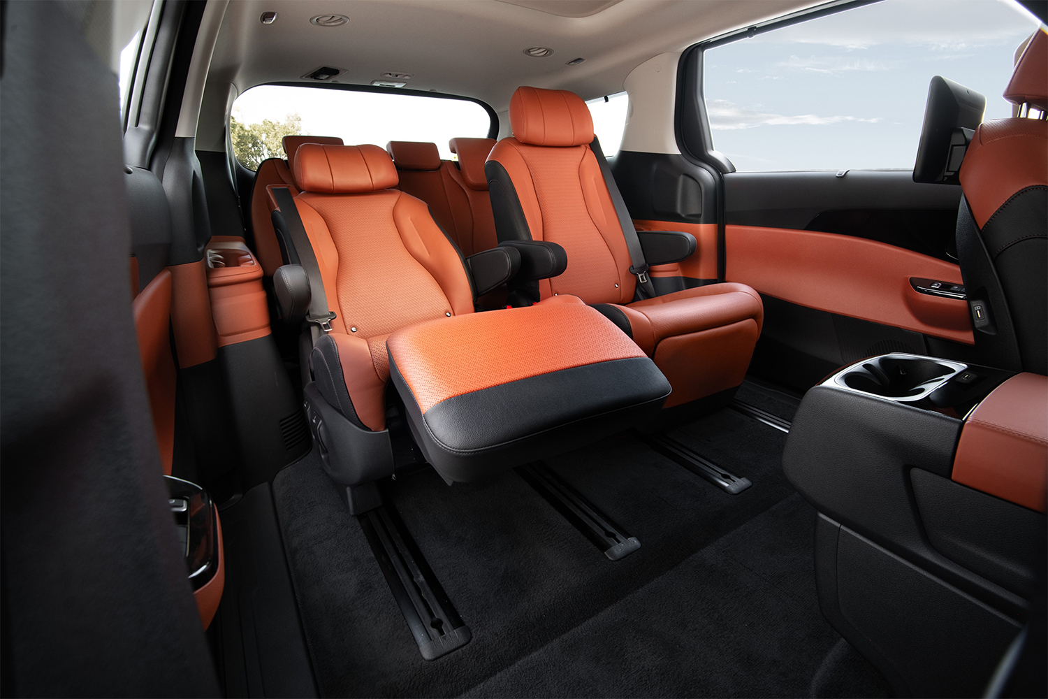 The second-row seats in the 2022 Kia Carnival SX Prestige, with one of the two captain's chairs reclining