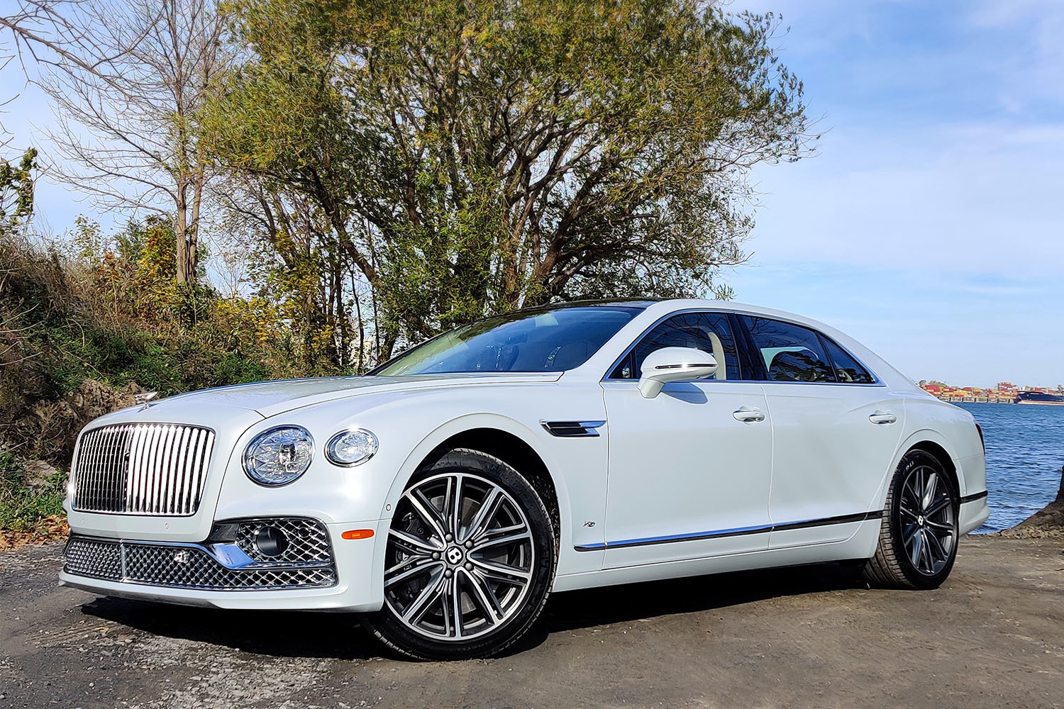 The front third of the 2022 Bentley Flying Spur luxury sedan in white