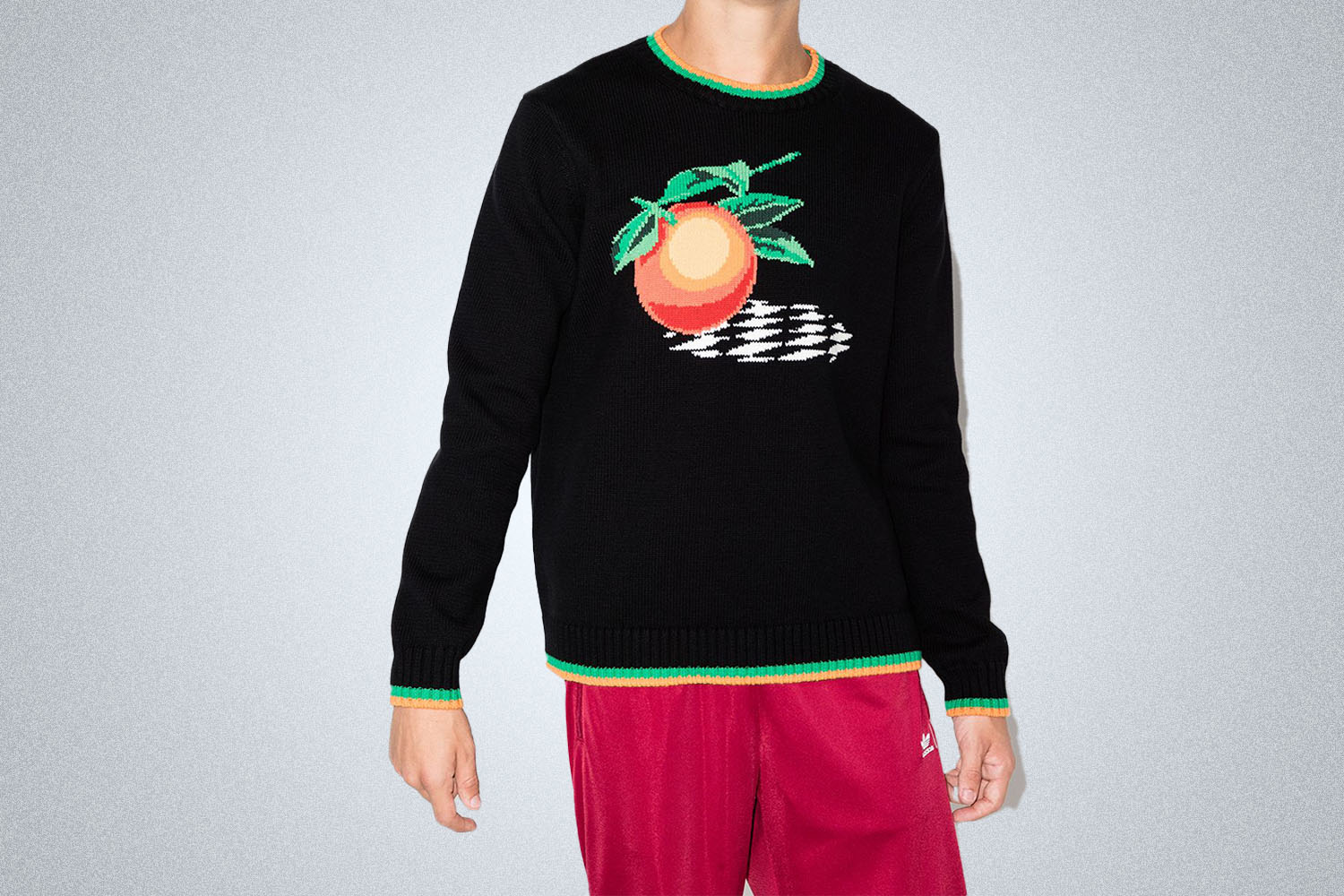 a sweater with an orange graphic on it