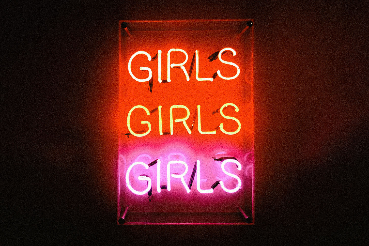 A lit neon sign reads "Girls Girls Girls"