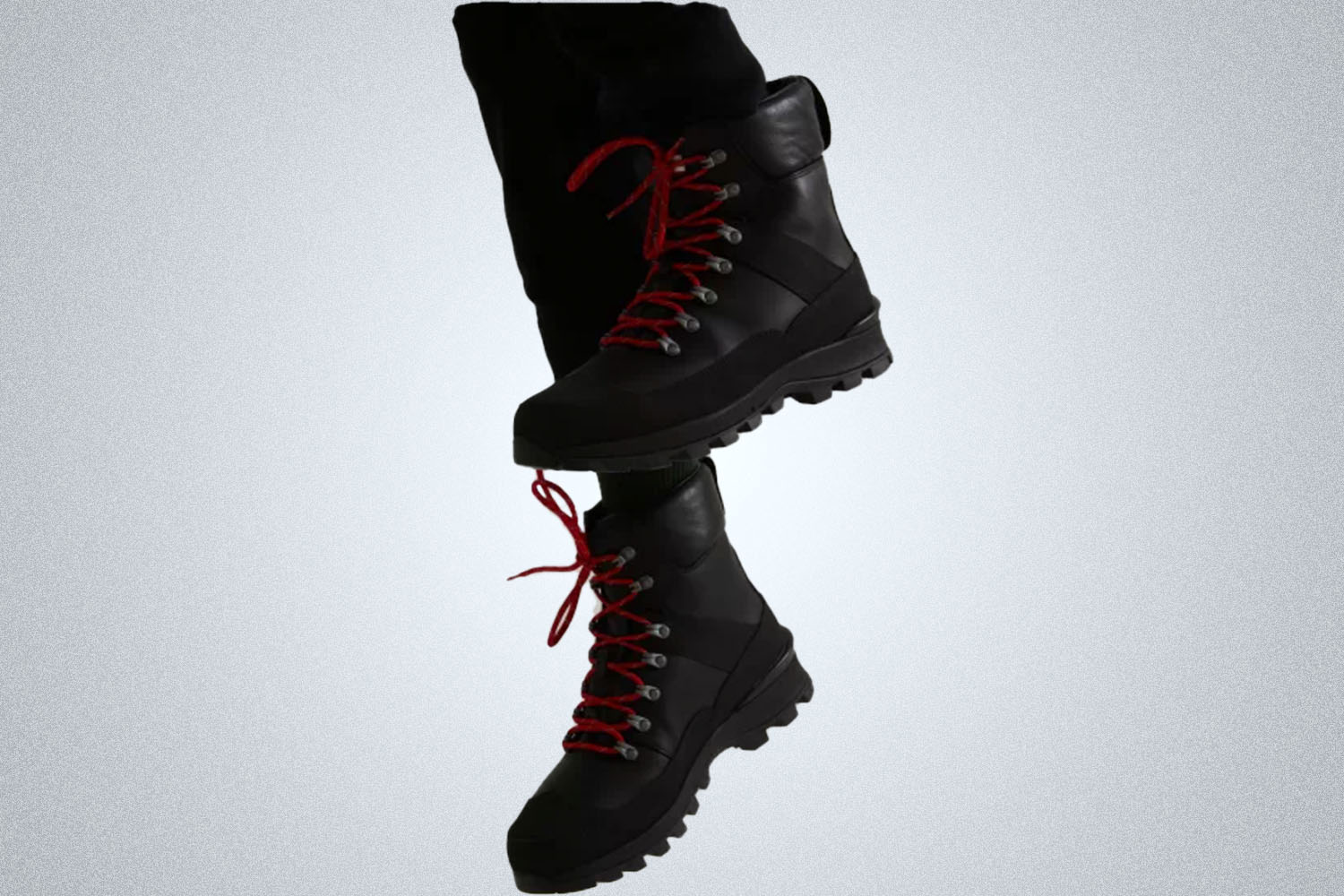 a pair of sturdy black boots on a model