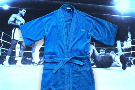 A blue robe given to the writer by Muhammad Ali, atop a scene from one of the boxer's fights