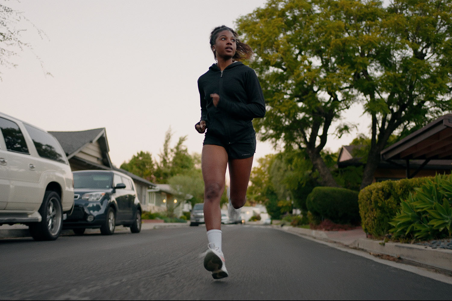 a girl running in a sporty black fleece outfit