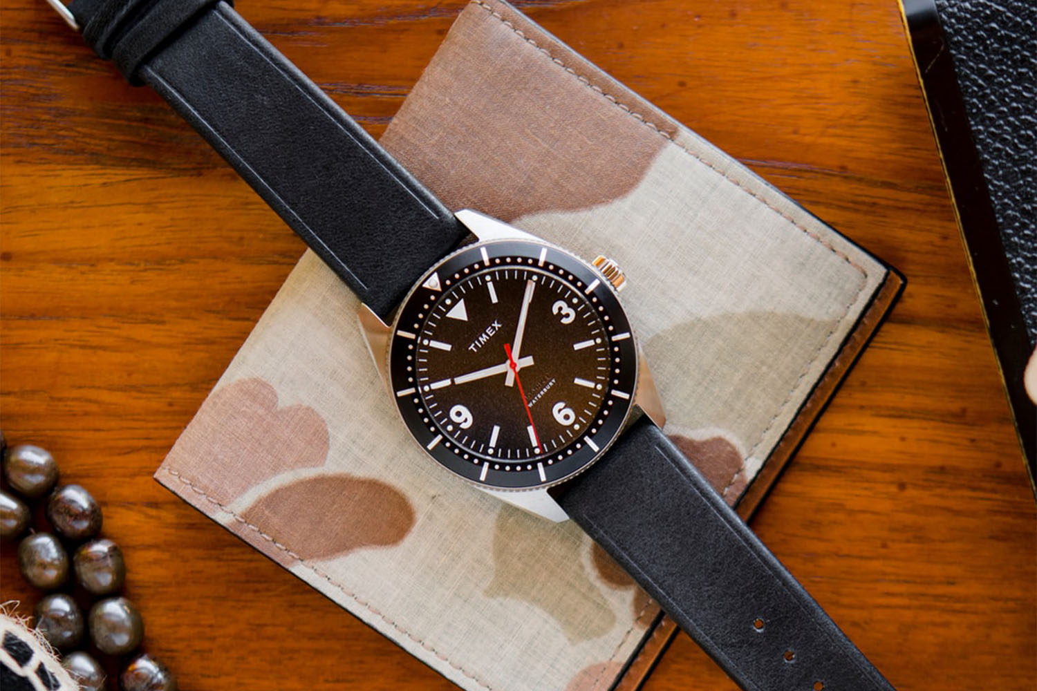 a Timex watch on a camp cloth and wood background