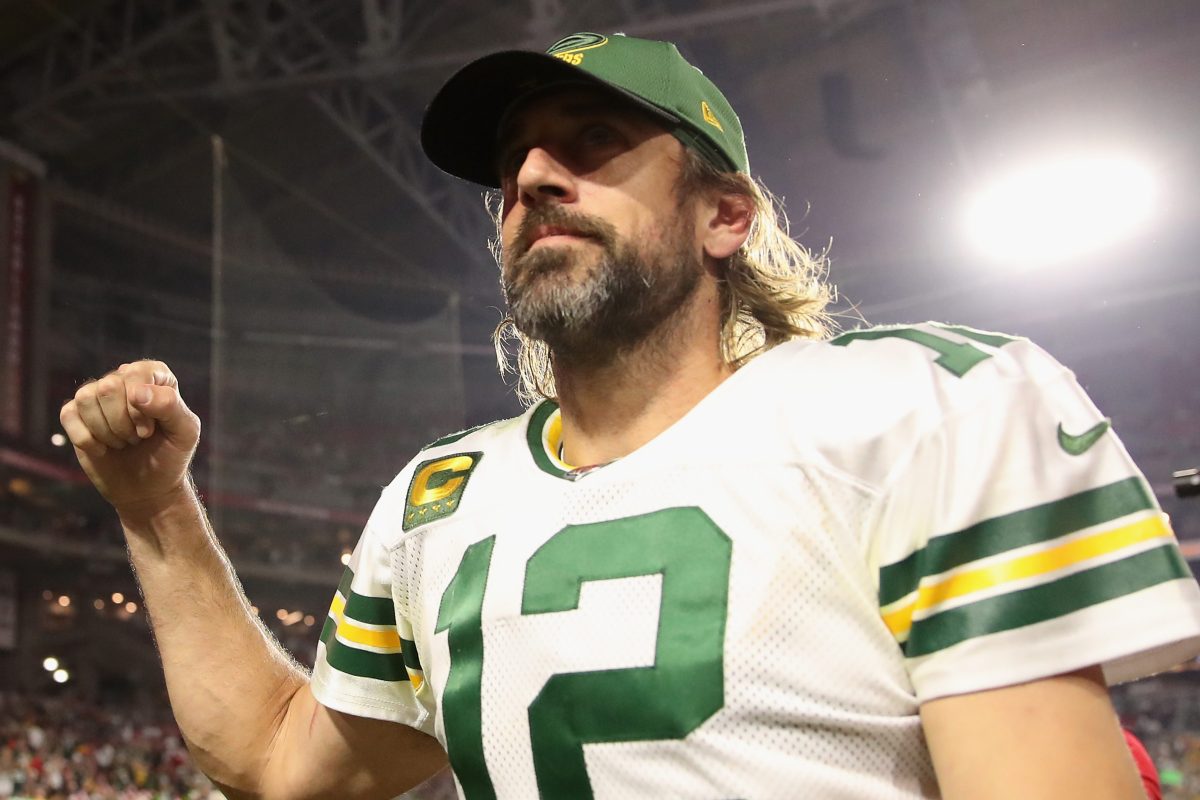 Aaron Rodgers walks off the field following a win over the Cardinals