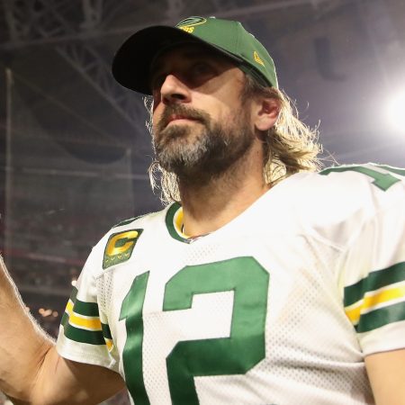 Aaron Rodgers walks off the field following a win over the Cardinals