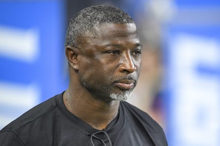 Aaron Glenn of the Detroit Lions looks on before a game at Ford Field