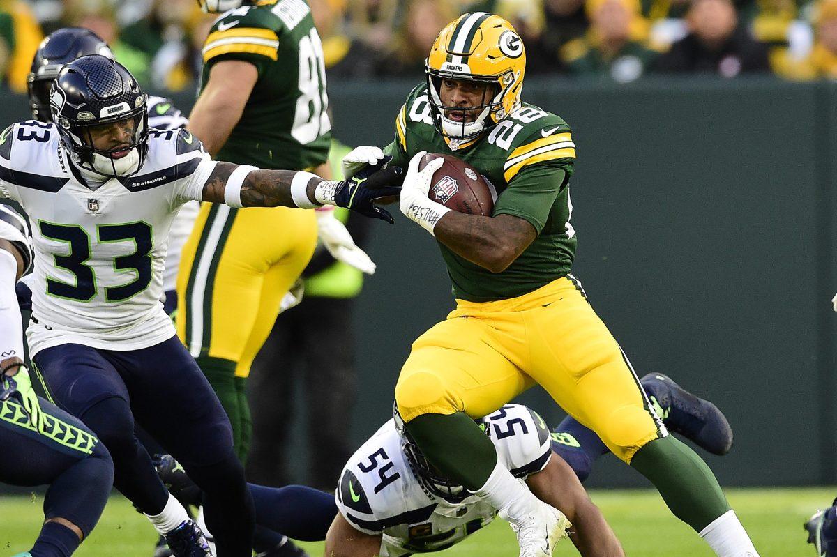 AJ Dillon of the Green Bay Packers carries the ball against the Seattle Seahawks at Lambeau Field