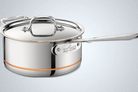 An All-Clad Copper Core saucepan on a blue background, on sale during the VIP Factory Seconds Sale from Home & Cook