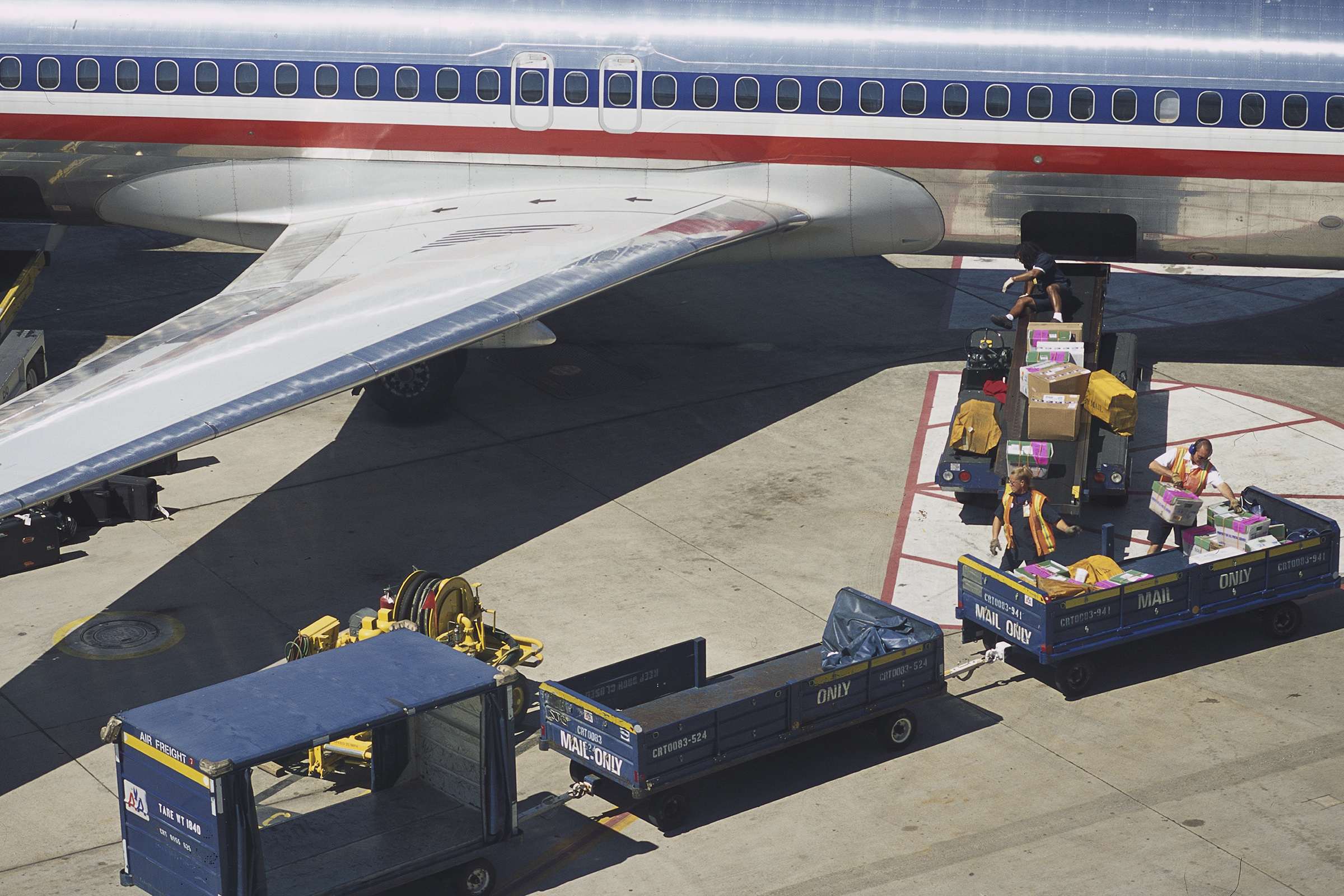 American Airlines' baggage handlers transport passenger's goods at Dallas-Fort Worth International Airport