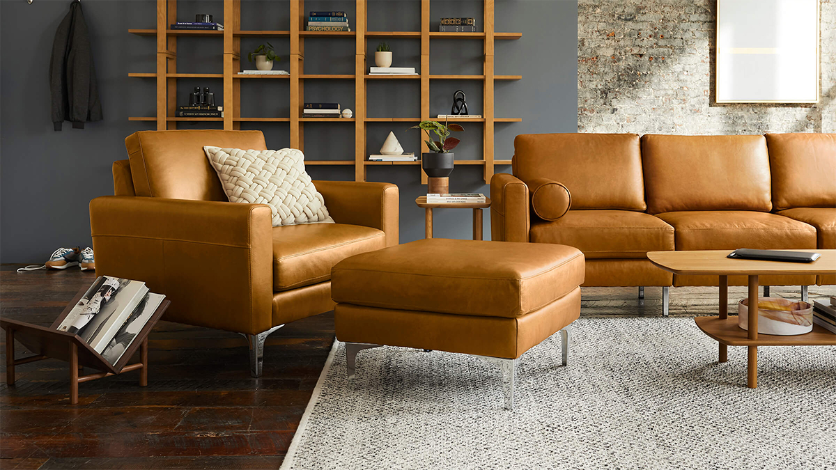 A leather armchair, ottoman and couch from Burrow, all of which are on sale during the furniture brand's early Black Friday sale in November 2021