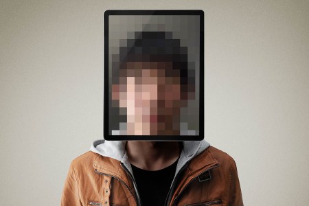 Portrait of man with digital tablet with his face pixelated - a proposed Australian law would force social media users to identify themselves via a 100-point system