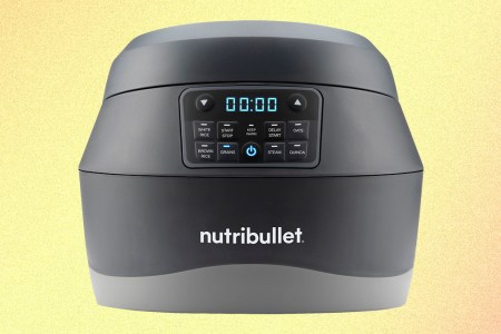 The Nutribullet EveryGrain Cooker, a new grain cooking appliance, on a yellow and orange background. We tested and reviewed the kitchen appliance to see if it's worth buying.