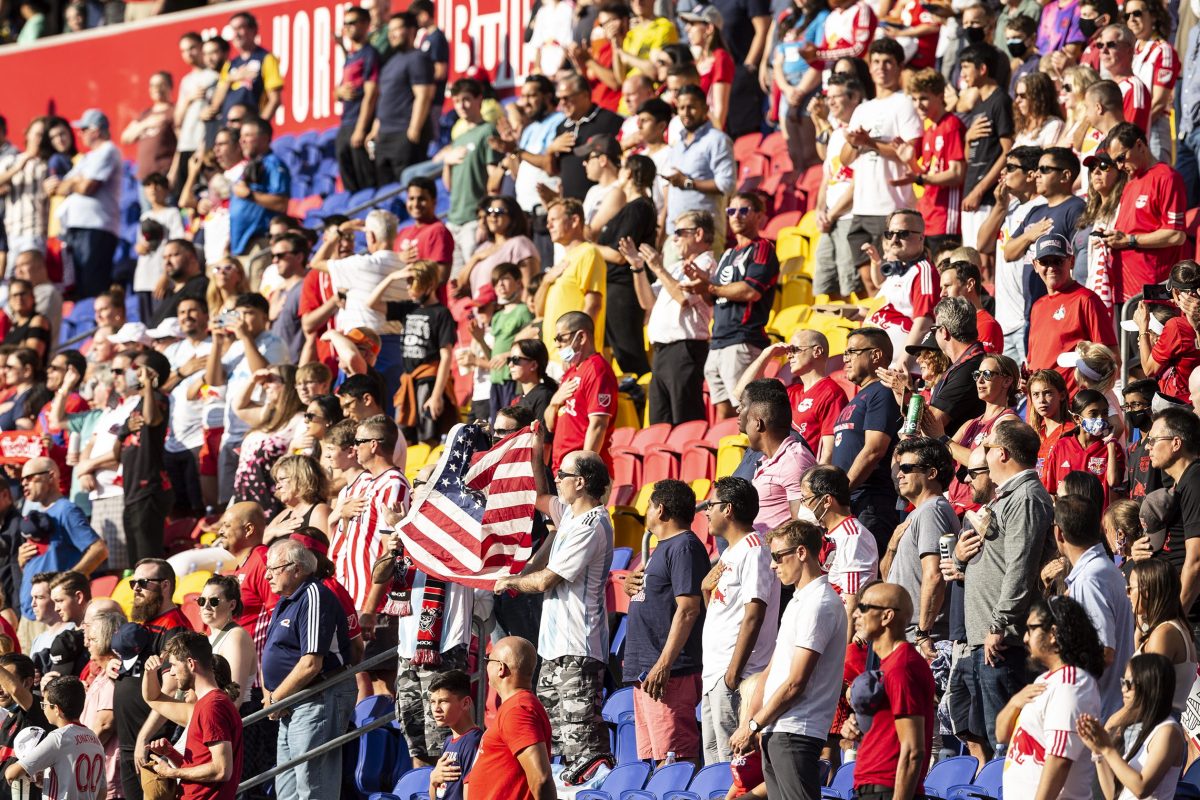 MLS fans in New Jersey wave the American flag during the national anthem