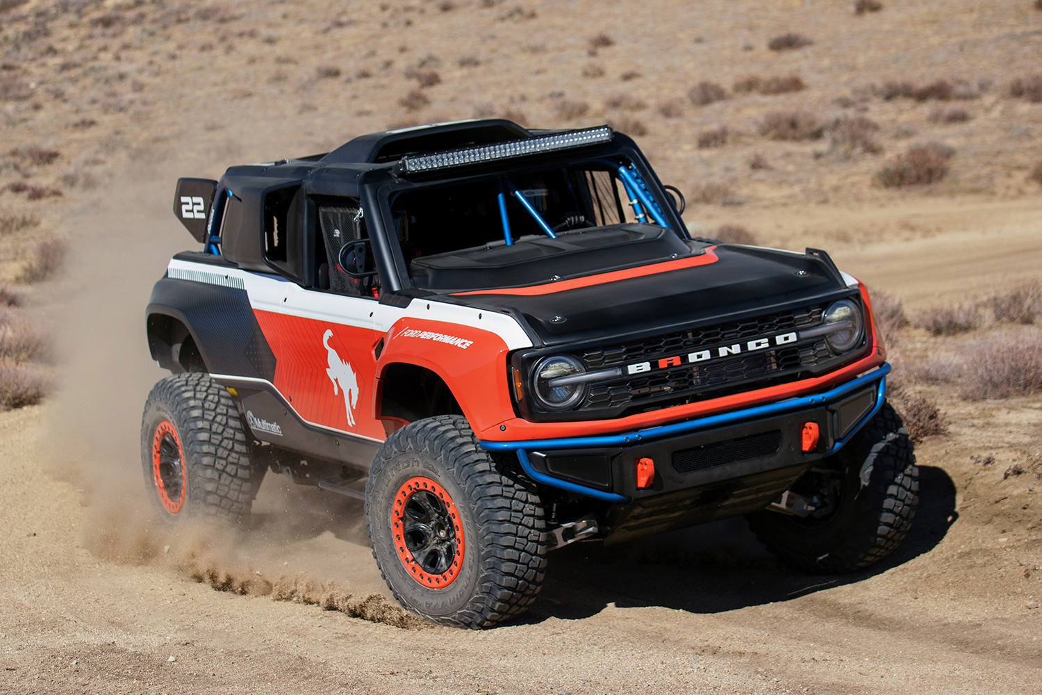 The 2023 Ford Bronco DR, or Desert Racer, ripping around on sandy roads