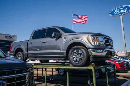 A grey Ford F-150 pickup truck on a raised platform in a Ford dealership in Houston Texas on October 28, 2021