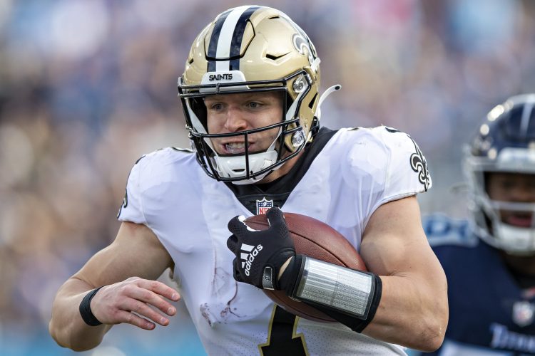 Taysom Hill of the New Orleans Saints runs the ball against the Titans