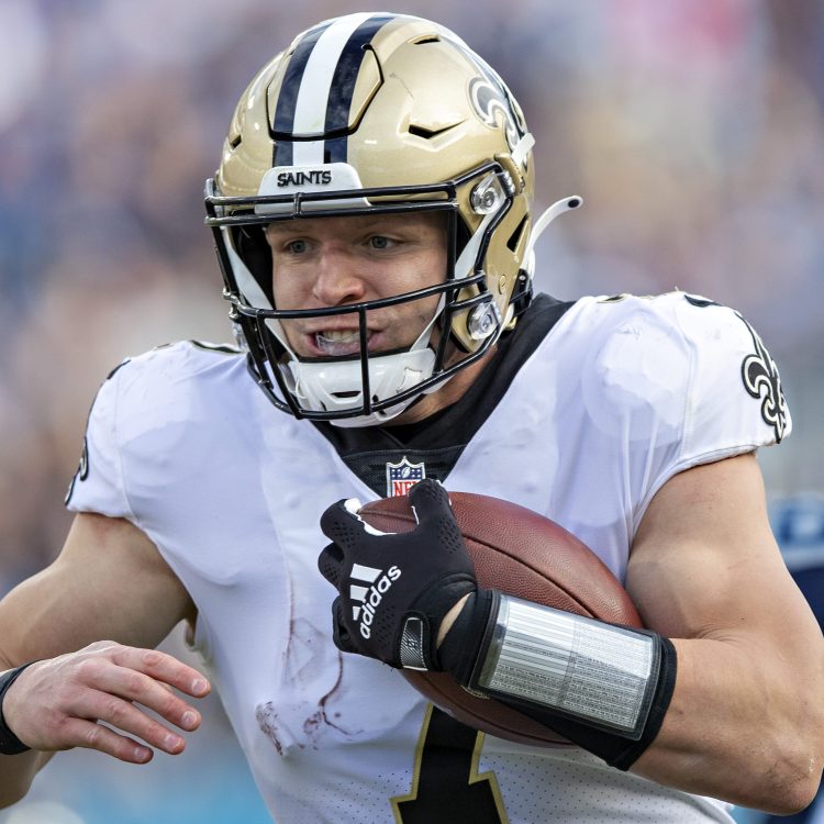 Taysom Hill of the New Orleans Saints runs the ball against the Titans