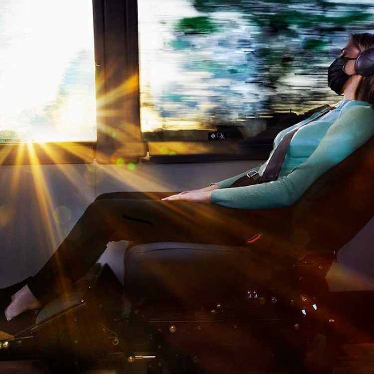 A woman sleeping on a reclining chair on The Jet, a new luxury bus line