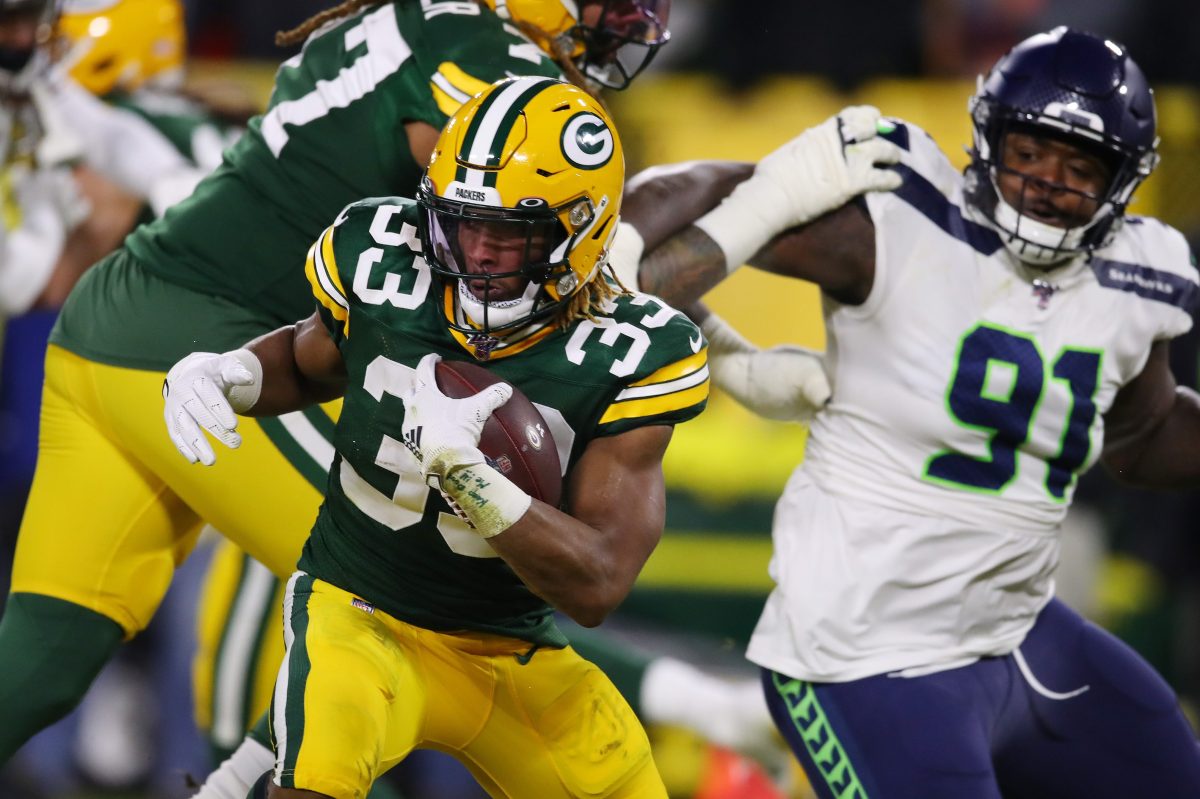 Aaron Jones carries the ball against the Seattle Seahawks during the NFC divisional round of the playoffs