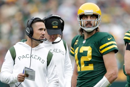 Aaron Rodgers talks with Green Bay Packers head coach Matt LaFleur during a game
