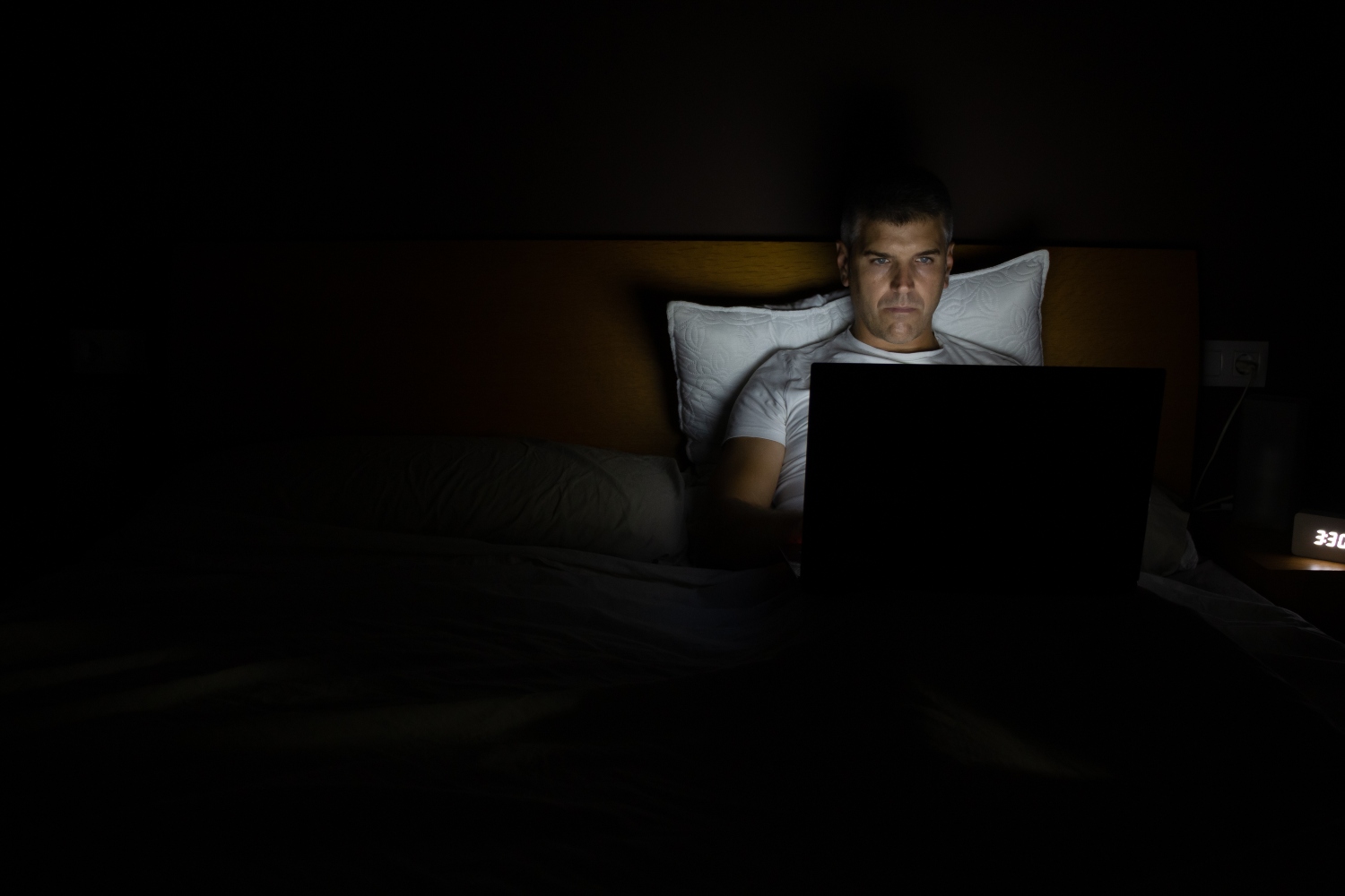 Man on his laptop in the bed at night. Platforms like Remojo promise to help men kick their porn habits
