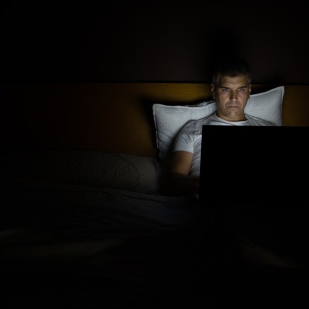 Man on his laptop in the bed at night. Platforms like Remojo promise to help men kick their porn habits