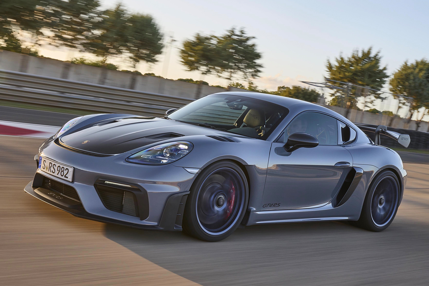 The new Porsche 718 Cayman GT4 RS racing down a track