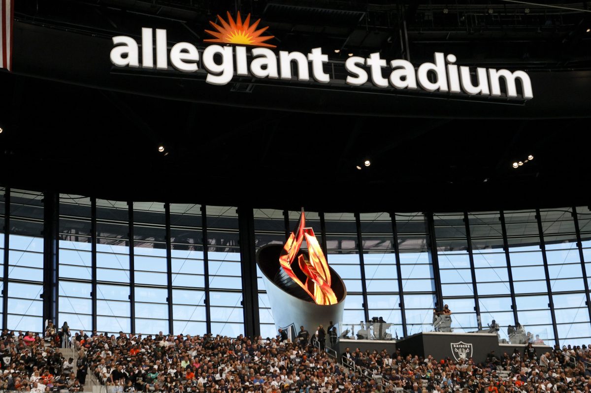 Fans sit in front of the Al Davis Memorial Torch at Allegiant Stadium. Las Vegas has the most expensive football viewing experience, according to a new study.