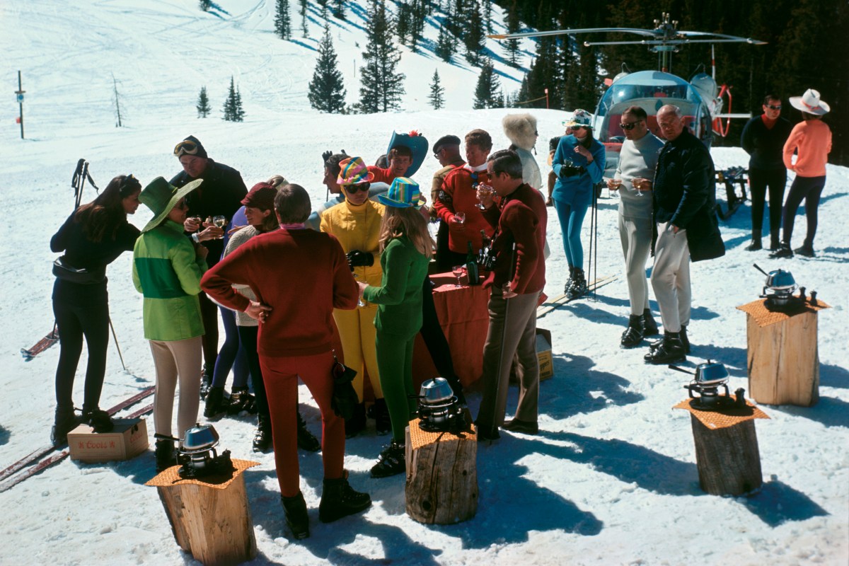 A group of skiers congregate over an on-piste fondue spread at Aspen Snowmass in 1967