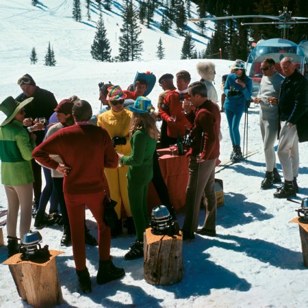 A group of skiers congregate over an on-piste fondue spread at Aspen Snowmass in 1967