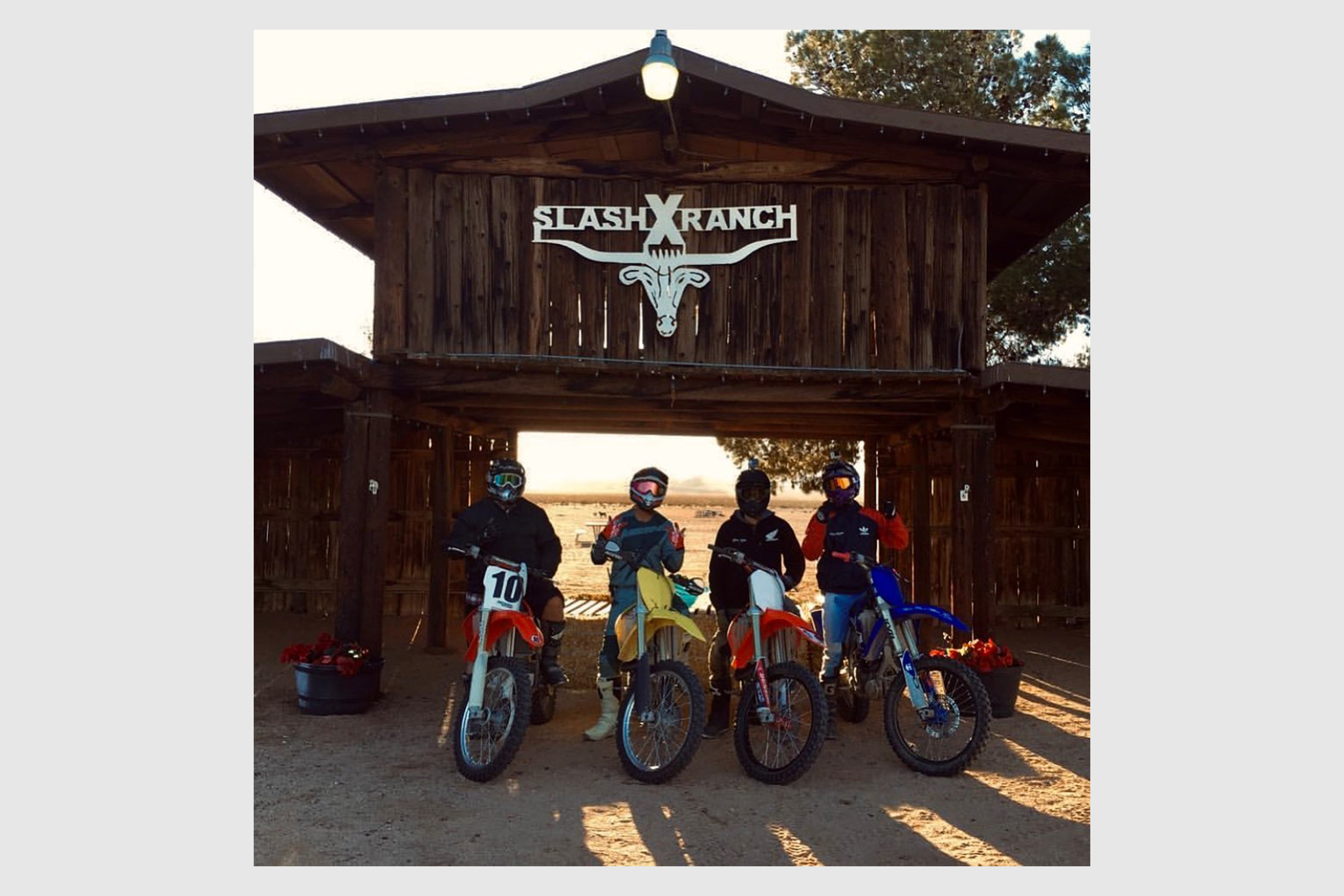 Four motorcyclists in front of Slash X Ranch.