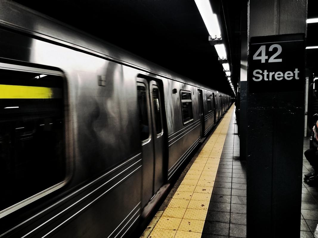 The Times Square Subway Station showing a train in the station and a sign reading "42 Street"
