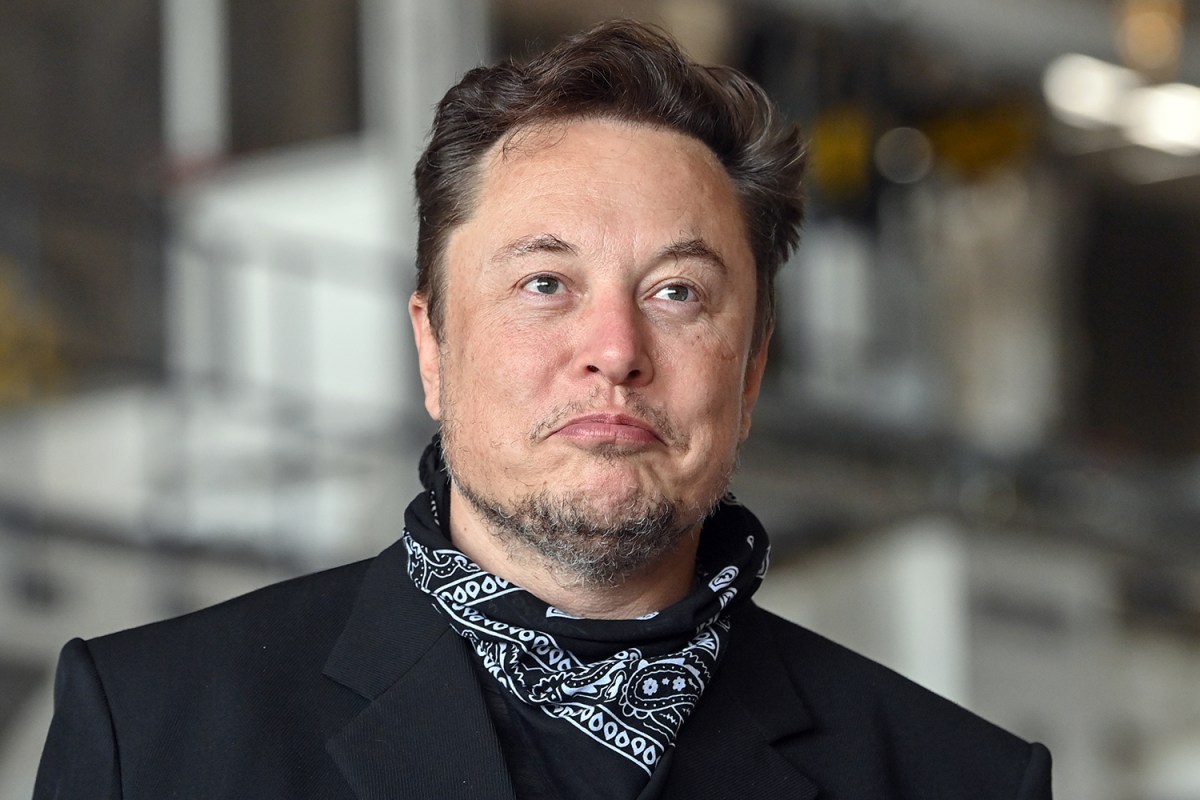 Tesla CEO Elon Musk wearing a black bandana around his neck and making a goofy face at the Gigafactory in Grünheide, Germany on August 13, 2021