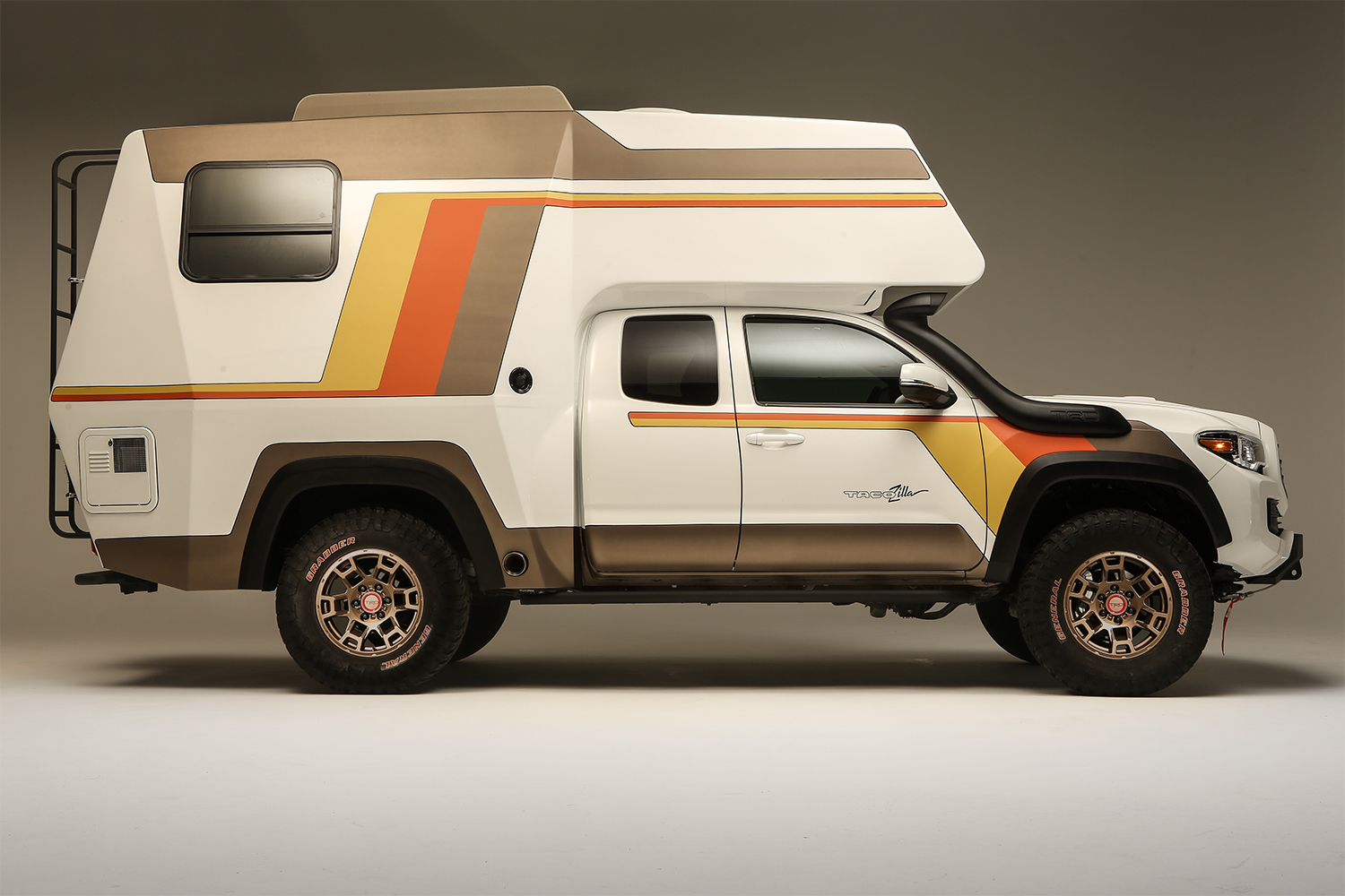The side profile of the Toyota Tacozilla Tacoma Camper built for SEMA 2021. The retro overlander features a shower, kitchen and tons of sleeping space.