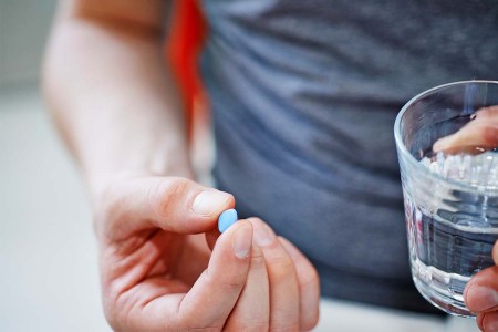 A man holding a Viagra pill.