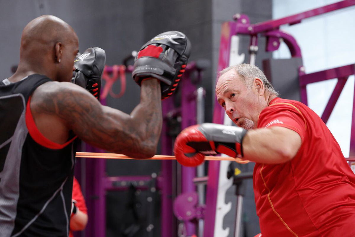 A man sparring with his trainer in "The Biggest Loser."